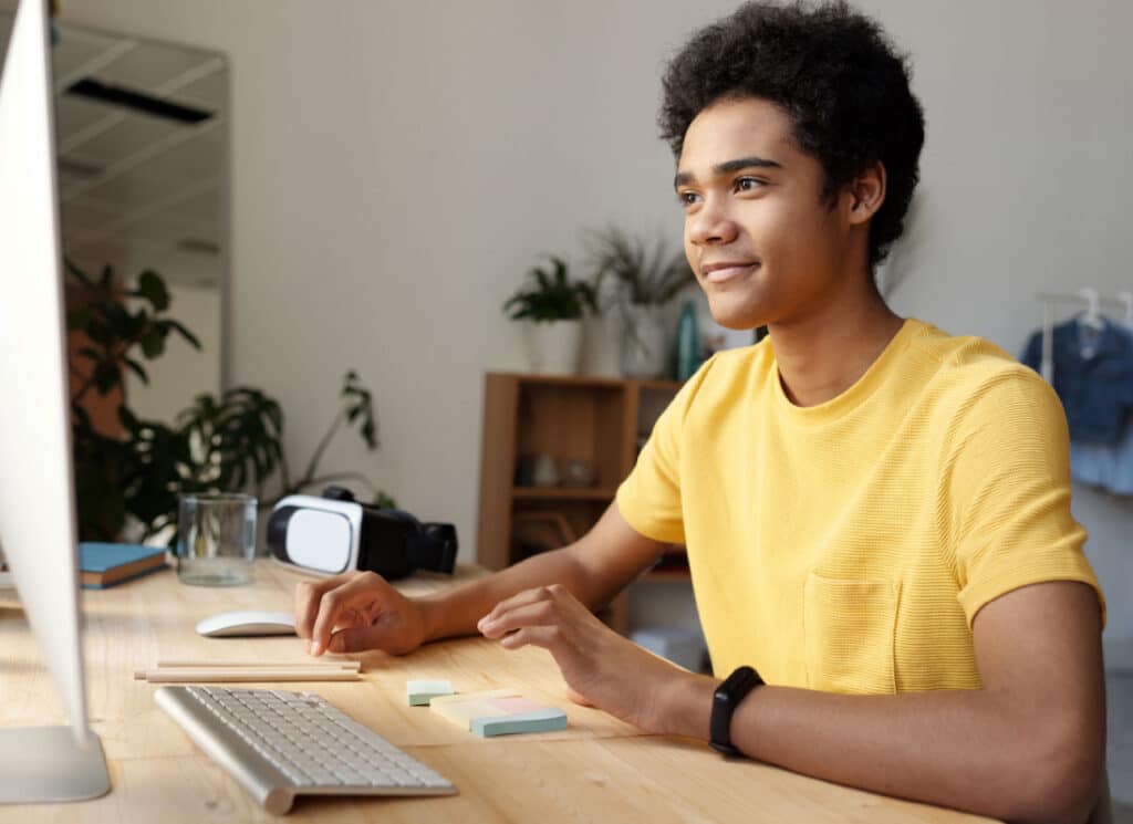 Adolescent travaillant sur un ordinateur